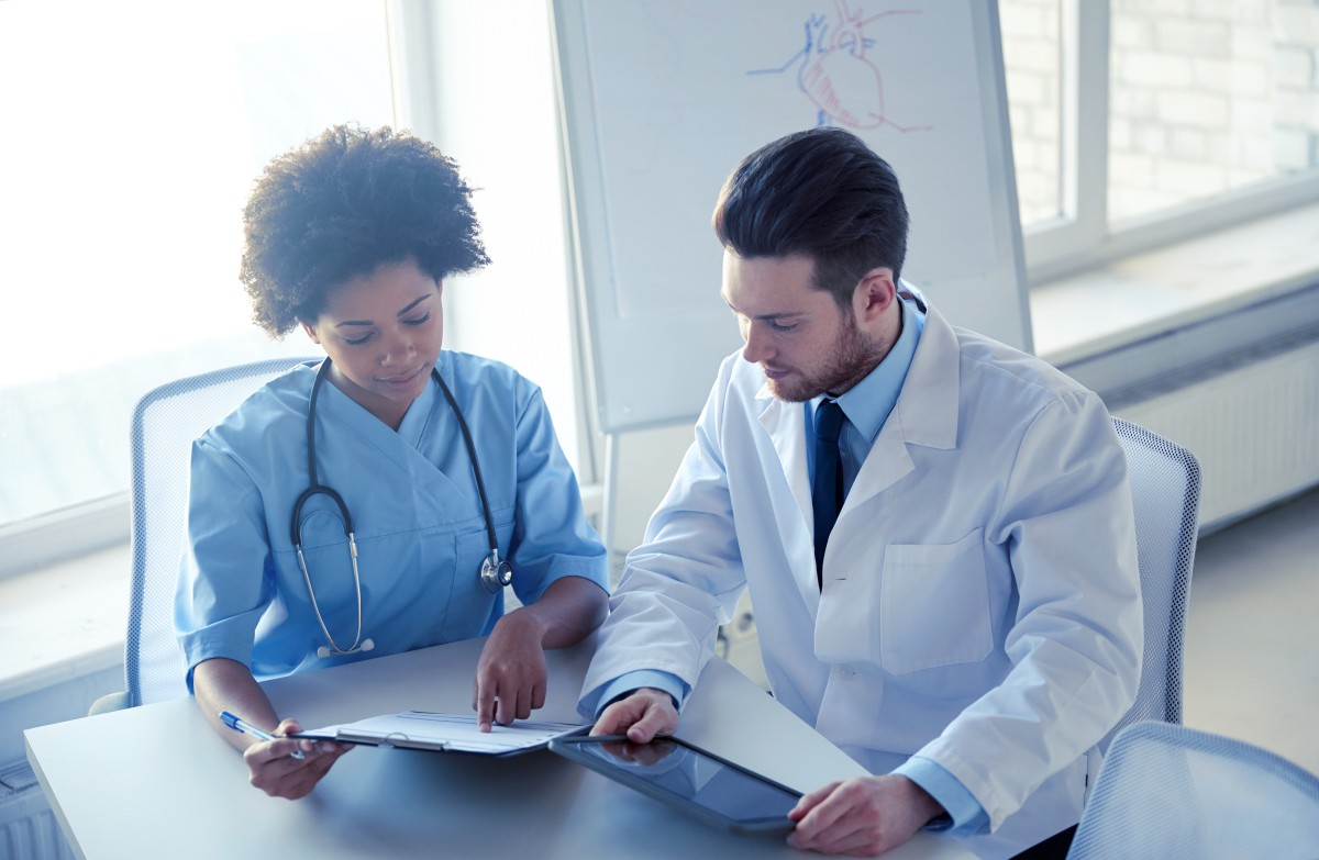 doctors with tablet pc and clipboard at hospital