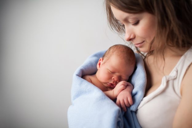 Loving mother holding newborn baby